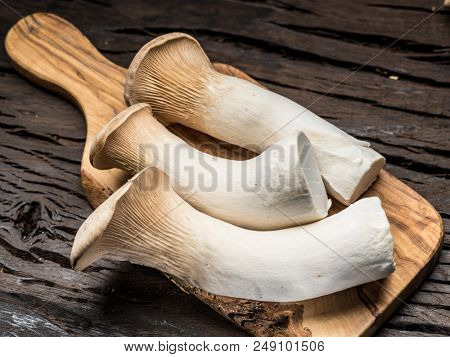 King oyster mushrooms on the wooden background.