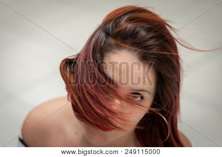 Close-up Portrait Of Girl With Wind-blown Red Hair In Front Of The Face, Horizontal Image