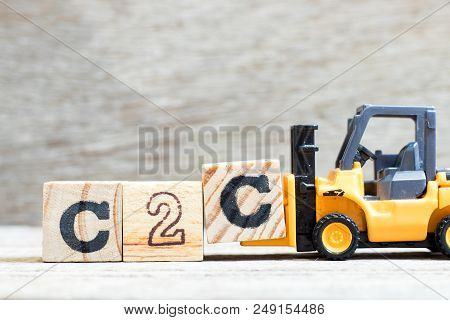 Toy Forklift Hold Letter Block C To Complete Word C2c (abbreviation Of Consumer To Consumer) On Wood