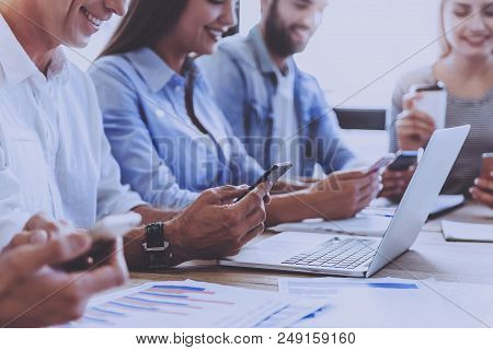 Business People In Smart Casual Wear Using Gadgets And Smiling. Business People Meeting Conference D