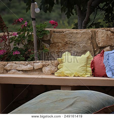 A Relaxing Spot With Pastel Colored Cushions In The Garden.