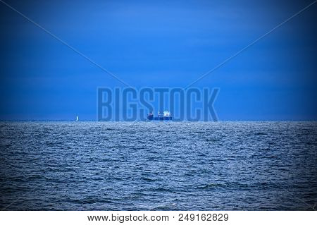 Ships Standing In The Roadstead.
Slightly Wavy Surface Of The Sea. Small Waves Ripple The Surface Of