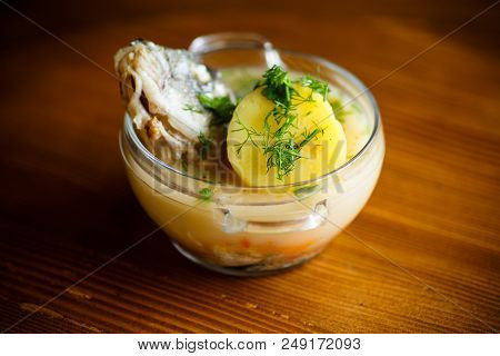 Vegetable Soup With Fish In A Glass Bowl On A Wooden Table