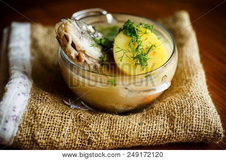 Vegetable Soup With Fish In A Glass Bowl On A Wooden Table