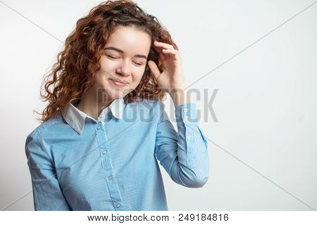 Lauging Young Female With Long Red Hair. Copyspace. Girl Plaing With Her Curly Hair