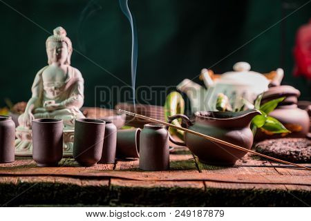 Chinese Tea Set And Accessories Made Of Yixing Clay On An Old Wooden Table.