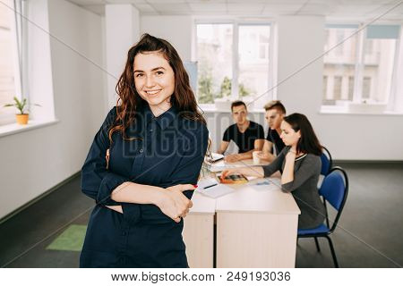 Young Successful Business Woman Portrait With Colleagues Meeting Behind Her. Friendly Atmosphere, Co