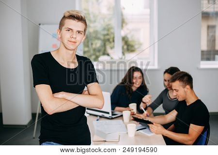 I Am The Part Of Cohesive Team. Young Successful Man Specialist Portrait With Colleagues Meeting Beh