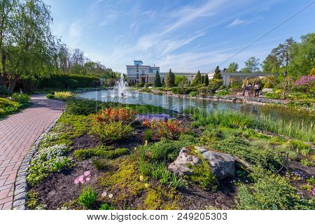 Landscape Design In A Park With A Fountain On The Lake Near The House