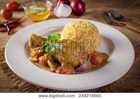 Curry Chicken And Rice On Wooden Table