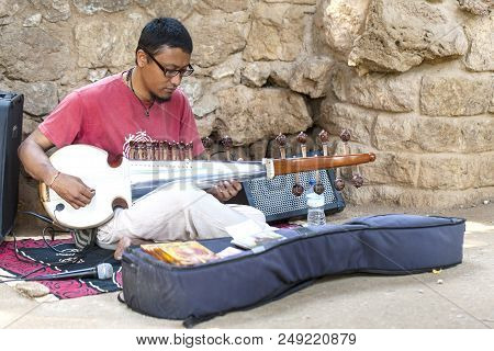 Barcelona, Spain 9 June 2018:  Unknown Street Musician Playing The Indian Sitar Instrument On One Of