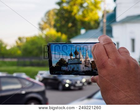 A Man Is Taking Pictures Of A Church In Yaroslavl On The Phone.