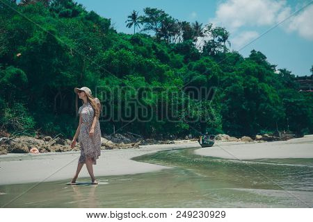 Handsome Girl On The Beach Background. Portrait Of A Woman In White Clothes On The Sea