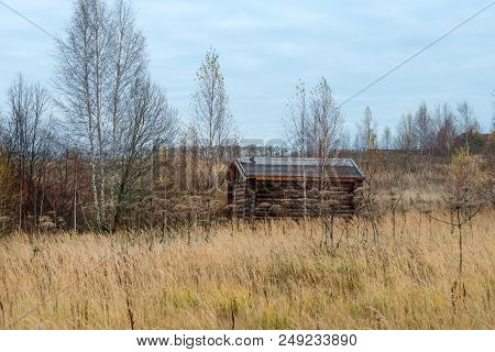 Wooden House Standing In A Thicket. Autumn Landscape.