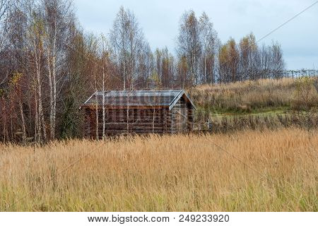 Wooden House Standing In A Thicket. Autumn Landscape.