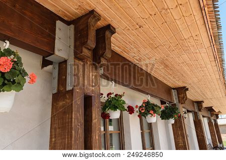 Closeup Of Wood Beam And Pillar Junction Professionally Connected By Metal Screw Plate. Exterior Roo