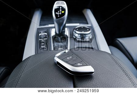 Closeup Inside Vehicle Of Wireless Key Ignition. Start Engine Key. Car Key Remote In Black Perforate