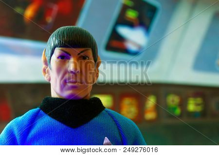 JUL 11 2018: Recreation of a scene from Star Trek the Original Series with a portrait of Mr. Spock at his science station on the bridge of the USS Enterprise - vintage Mego action figure