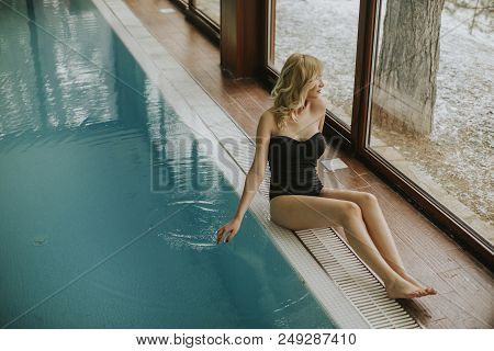 Pretty Young Woman Relaing By The Swimming Pool