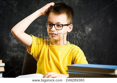 Cheerful Boy With Bunch Of Books Thinking About School, Education Abstract
