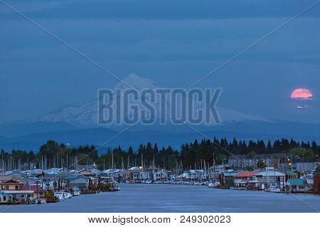 Full Moon Rising Behind Mount Hood At Hayden Island In Portland Oreogn During Blue Hour