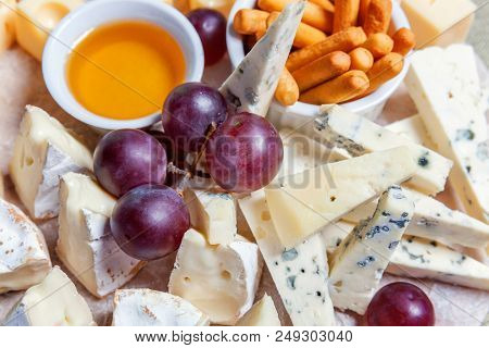 Board With Different Types Of Cheese: Dor Blu, Chedar, Parmesan, Brie, Honey Sauce, Finger Bread And