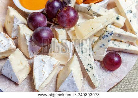 Board With Different Types Of Cheese: Dor Blu, Chedar, Parmesan, Brie, Honey Sauce, Finger Bread And