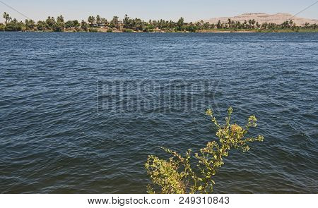 View Across Lareg Wide River Nile At Luxor Egypt To West Bank Through Rural Countryside Landscape