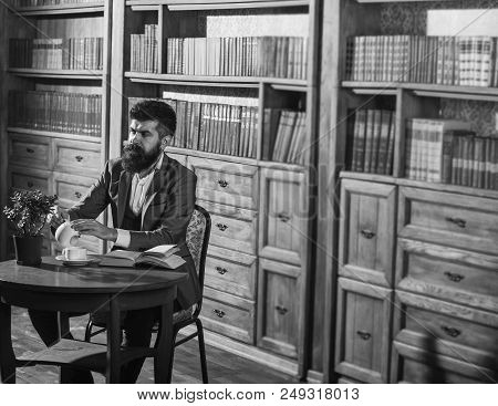 Man In Classic Suit Sits In Vintage Interior, Library, Book Shelves On Background. Aristocrat On Bus