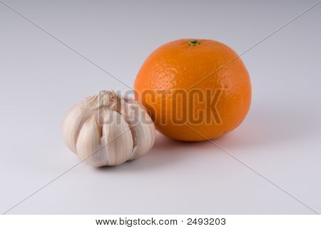 Knoblauch und reif Orange auf hellem Hintergrund