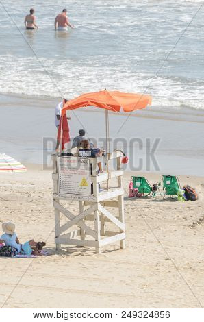 Virginia Beach, Va-august 31, 2017:  Lifeguard Watches Swimmers From Lifeguard Booth A On The Beach 