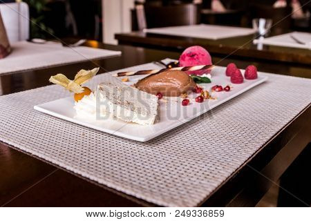 Piece Of Brown Mousse A U Chocolate Sweet Dessert And Decoration On A White Plate Background