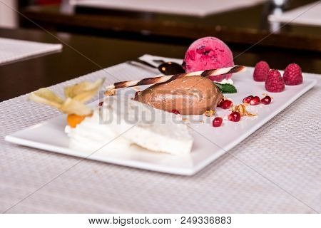 Piece Of Brown Mousse A U Chocolate Sweet Dessert And Decoration On A White Plate Background