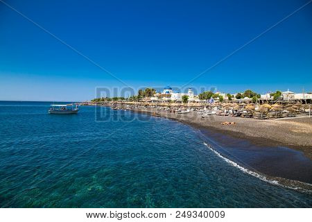 PERMISSA, GREECE- JUN 11, 2016: Boat for Kamari at Permissa black sand beach in Santorini on Jun 11, 2016. Greece. 
