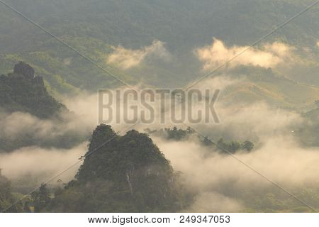 Rock Mountain Protruding From Rice Field. Morning Fog On Sunrise In The Phulanka, Phayao Thailand.
