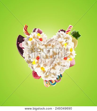 Milk Shake With Sweets And Whipped Cream, Heart Form Front View. Crazy Freakshake Food Trend. Front 
