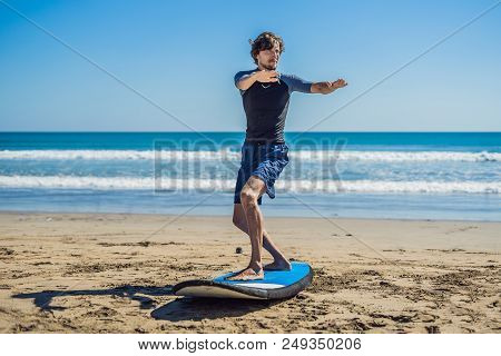 Young Man Surfer Training Before Go To Lineup On A Sand Beach. Learning To Surf. Vacation Concept. S