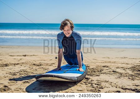 Young Man Surfer Training Before Go To Lineup On A Sand Beach. Learning To Surf. Vacation Concept. S