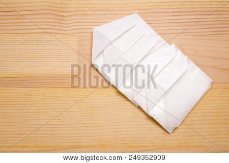 Medicine Powder Wrapped In Linked Paraffin Paper On Wood Table