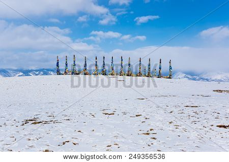 Wooden Ritual Pillars With Colorful Ribbons On Cape Burkhan, Lake Baikal, Olkhon Island, Siberia, Ru
