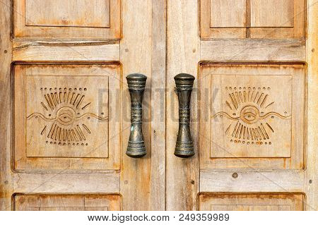 Wooden Brown Door With Handles And Decoration