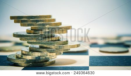 Euro Coins Stacked On Checkers Table For Economy Or Investment Concept.