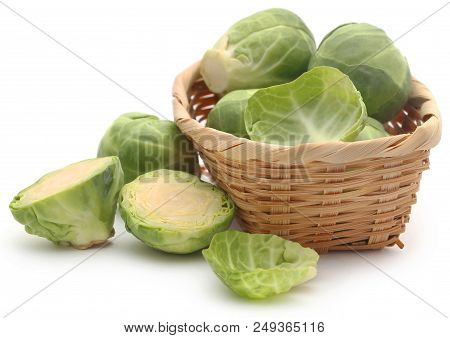 Rosenkohl Or Brussels Sprouts In A Basket Isolated Over White Background