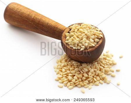 Peeled Sesame Seeds In A Spoon Over White Background