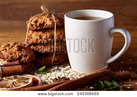 White Porcelain Mug Of Black Tea Or Earl Grey And Pile Of Sweet Cookies On Flat Piece Of Wood Over R