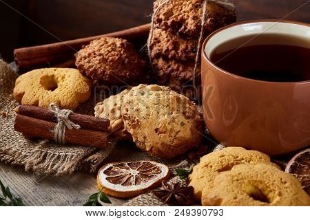 Cookies With Cinnamon And Two Cups Of Tea On A Burlap Napkin, Selective Focus, Close-up, Top View. D