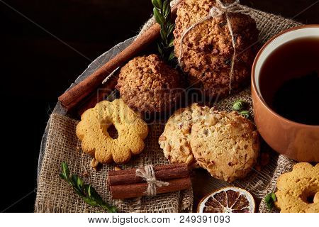 Cookies With Cinnamon And Two Cups Of Tea On A Burlap Napkin, Selective Focus, Close-up, Top View. D