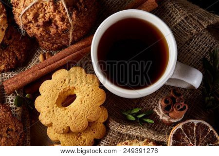 Cookies With Cinnamon And Two Cups Of Tea On A Burlap Napkin, Selective Focus, Close-up, Top View. D