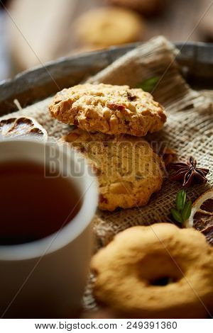 Cookies With Cinnamon And Two Cups Of Tea On A Burlap Napkin, Selective Focus, Close-up, Top View. D