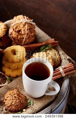 Cookies With Cinnamon And Two Cups Of Tea On A Burlap Napkin, Selective Focus, Close-up, Top View. D